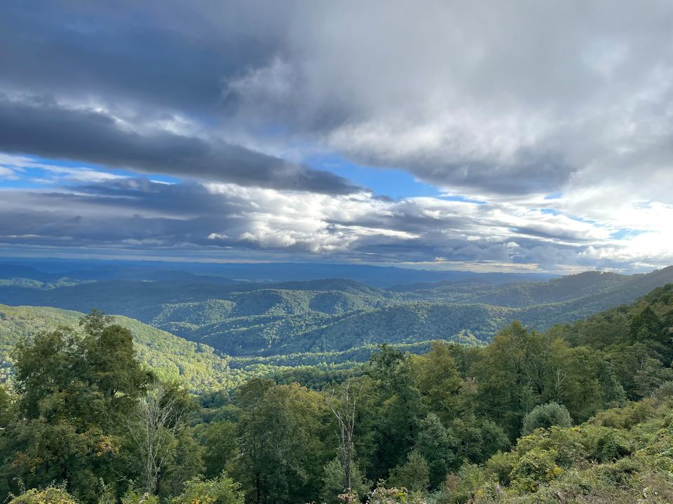 Green ridgelines rolling to the horizon from a Blue Ridge Parkway overlook