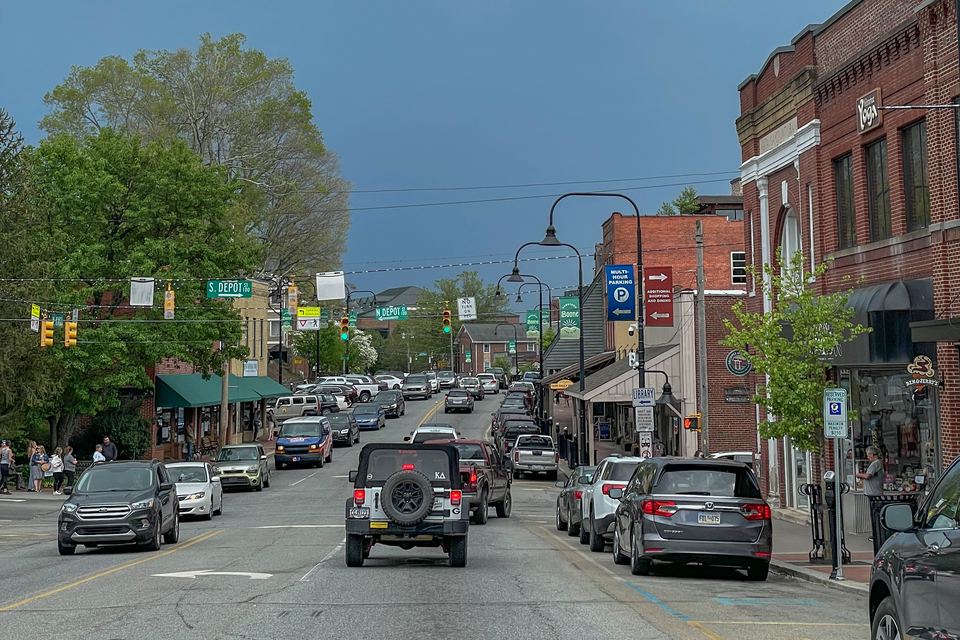 King Street in downtown Boone with green trees and storefronts in summer